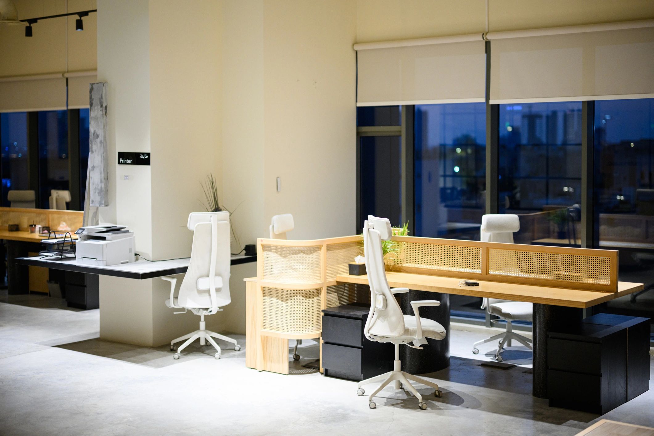 Modern office workspace with desks and city views